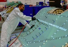 Northrop Grumman mechanic uses FILLS light projected work instructions to speed the assembly of an F-35 center fuselage.