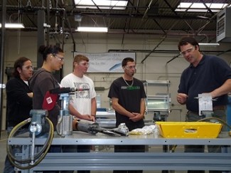 Washington Aerospace Training and Research Center students get a lesson in aluminum drilling techniques. (Photo courtesy Snohomish County Business Journal)